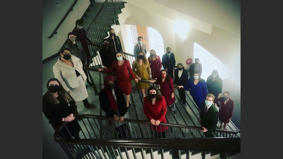 Photo Credit: Speech and Debate team on staircase with masks