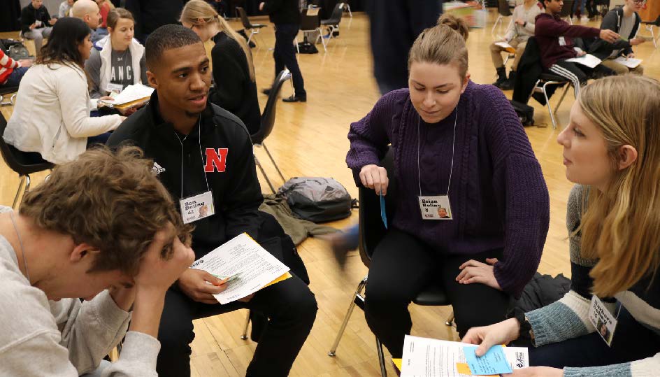 Students sitting in chairs in a circle.