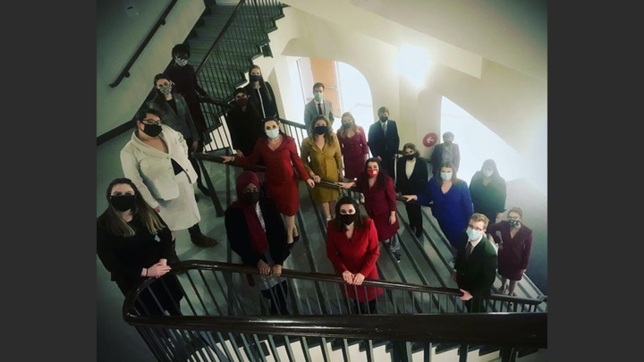 Speech and Debate team on staircase with masks