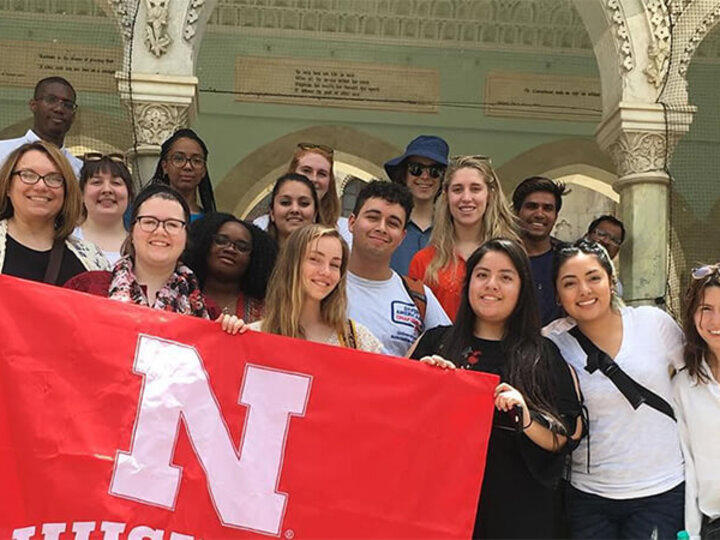 Students holding up a UNL flag